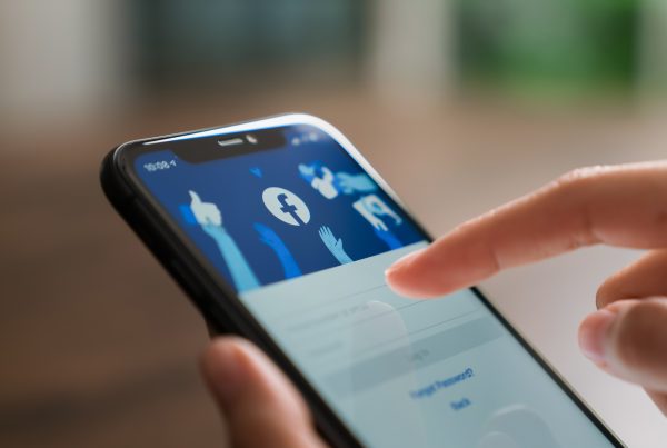 Someone logging into Facebook on a smartphone