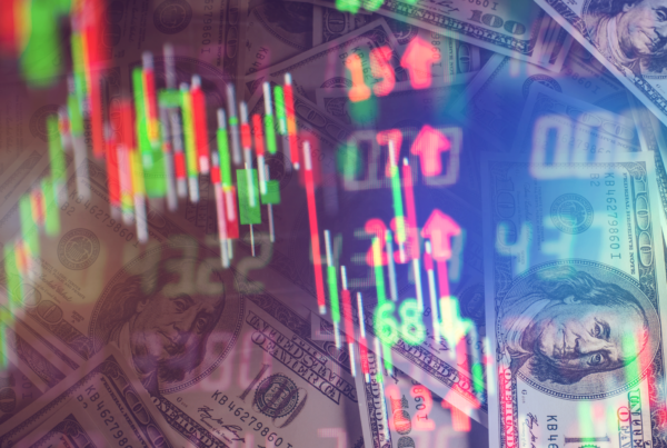 Reflection of stock trading screen with cash in the background.